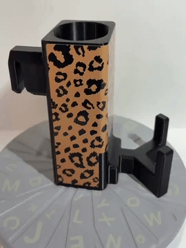A rotating black Paddle Saver™ with an attached Kitchen Kitty skin. The skin has a wildcat theme with black leopard spots on a tan background.