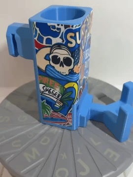 A rotating light blue Paddle Saver™ with an attached Serve's Up skin. The skin has a beach theme with the title "Surf's Up".